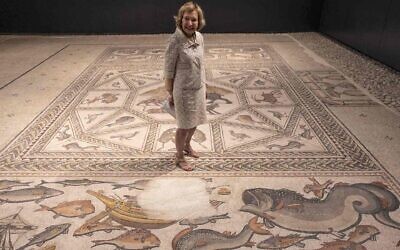Philanthropist Shelby White poses for a picture on the roughly 1,700-year-old Lod mosaic, ahead of the inauguration of a new visitors center she helped fund to display the prized piece in the Israeli city of Lod, June 27, 2022. (Menahem Kahana/AFP via Getty Images)