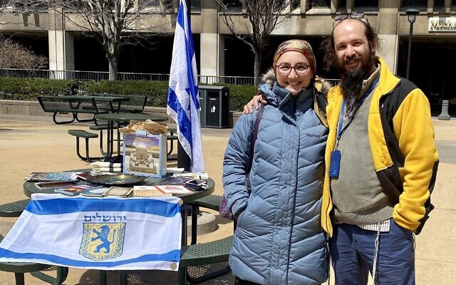 Rabbi Alexander Popivker (right) with his wife, Sarah, mounting a pro-Israel display on the campus of Cleveland State University. (Courtesy of Alex Popivker via JTA)