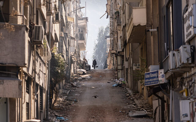 A man walks amid damaged buildings in an area heavily affected by the earthquake in Antakya on February 18, 2023.  (Sameer Al-Doumy/AFP)