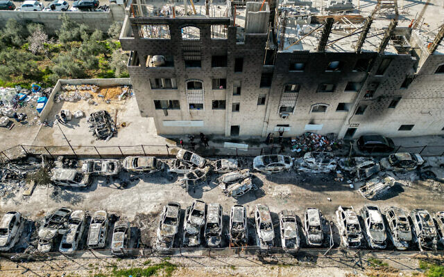 This picture taken on February 27, 2023 shows an aerial view of a scrapyard where cars were torched overnight, in the Palestinian town of Huwara near Nablus in the West Bank (RONALDO SCHEMIDT/AFP)