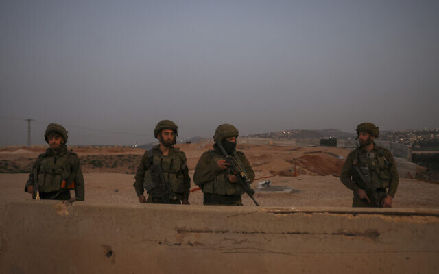 IDF soldiers patrol the main road in Huwara town in the West Bank, on February 27, 2023. (Ronaldo Schemidt/AFP)