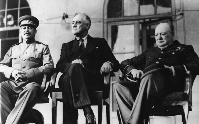 Franklin D. Roosevelt, flanked by Winston Churchill, right, and Joseph Stalin, sit on chairs outside the Russian embassy during their conference between November 28 and December 1, 1943, in Tehran, Iran. (AP Photo)