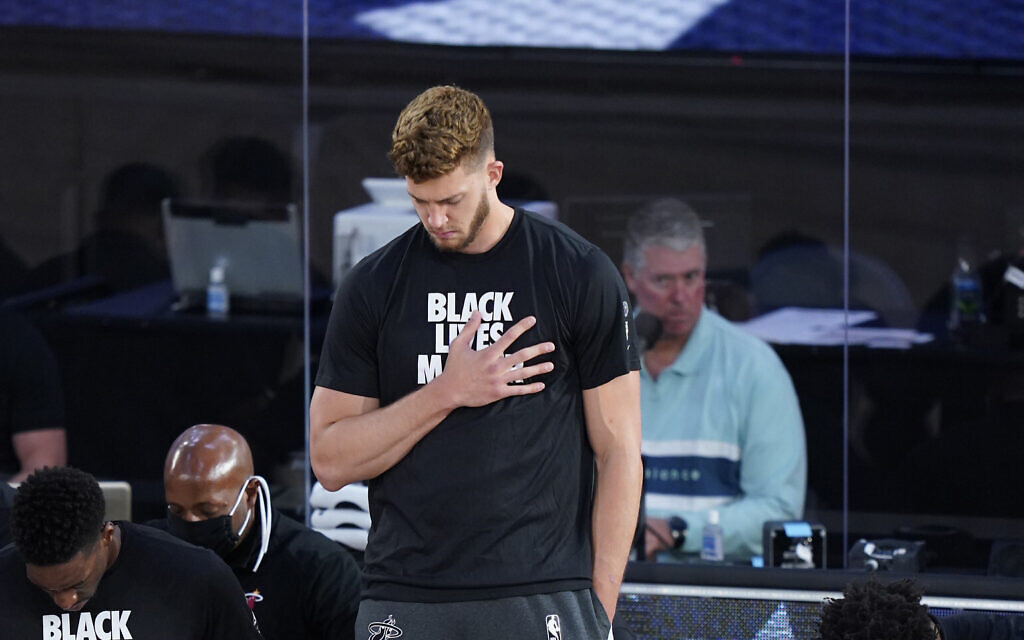 Miami Heat's Meyers Leonard stands for the national anthem before an NBA basketball game against the Phoenix Suns, Saturday, August 8, 2020, in Lake Buena Vista, Florida. (AP Photo/Ashley Landis, Pool)