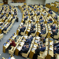 In this handout photo provided by The State Duma, The Federal Assembly of The Russian Federation, Russian lawmakers attend a session of the State Duma, the Lower House of the Russian Parliament in Moscow, Russia, Wednesday, November 23, 2022. (The State Duma, The Federal Assembly of The Russian Federation via AP)