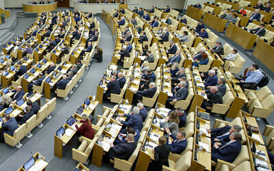 In this handout photo provided by The State Duma, The Federal Assembly of The Russian Federation, Russian lawmakers attend a session of the State Duma, the Lower House of the Russian Parliament in Moscow, Russia, Wednesday, November 23, 2022. (The State Duma, The Federal Assembly of The Russian Federation via AP)