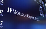 In this August 16, 2019, file photo, the logo for JPMorgan Chase & Co. appears above a trading post on the floor of the New York Stock Exchange in New York.  (AP Photo/Richard Drew)