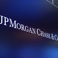 In this August 16, 2019, file photo, the logo for JPMorgan Chase & Co. appears above a trading post on the floor of the New York Stock Exchange in New York. (AP Photo/Richard Drew)