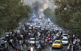 In this photo taken by an individual not employed by the Associated Press and obtained by the AP outside Iran, protesters chant slogans during a protest over the death of a woman who was detained by the morality police, in downtown Tehran, Iran on September 21, 2022. (AP photo)