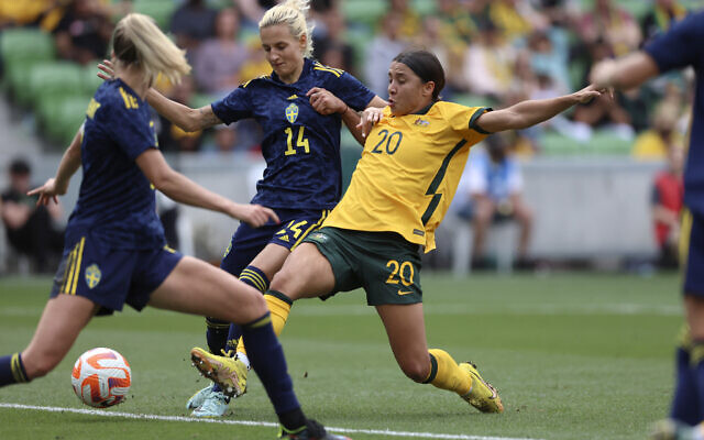 Australia's Sam Kerr (20) scores against Sweden's Nathalie Bjorn (14) during their women's friendly soccer match in Melbourne, Australia, November 12, 2022. (Asanka Brendon Ratnayake)
