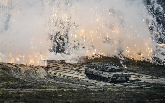 A Leopard 2 tank is seen in action during a visit of German Defense Minister Boris Pistorius at the Bundeswehr tank battalion 203 at the Field Marshal Rommel Barracks in Augustdorf, Germany, February 1, 2023. (AP Photo/Martin Meissner)