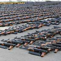 Assault rifles and missiles seized by the French navy lay on the deck of a ship at an undisclosed location February 1, 2023. (US military's Central Command via AP)