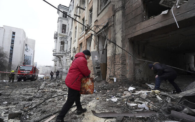 A person enters a residential building which was hit by a Russian rocket at the city center of Kharkiv, Ukraine, Sunday, Feb. 5, 2023. (AP/Andrii Marienko)