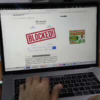 A computer screen displays a notice blocking the Wikipedia website through an online news site in Islamabad, Pakistan, Feb. 6, 2023 (AP Photo/Anjum Naveed)