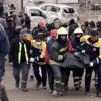 Firefighters carry the body of a victim in Diyarbakir, in southeastern Turkey, after an earthquake, Feb. 6, 2023. (AP Photo/Mahmut Bozarsan)