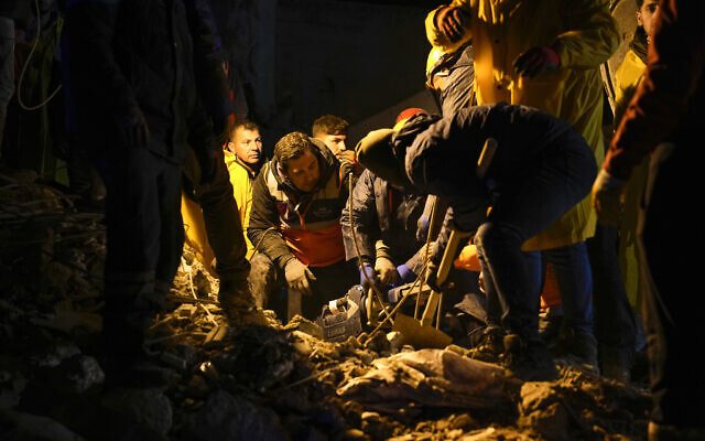 Emergency teams search in the rubble for people in a destroyed building in Adana, Turkey, February 6, 2023. (AP Photo/Khalil Hamra)