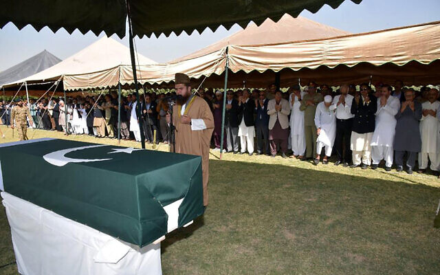 In this photo released by Inter Services Public Relations, military officials and others attend funeral prayer of Pakistan's former President Pervez Musharraf, in Karachi, Pakistan, Tuesday, Feb. 7, 2023. (Inter Services Public Relations via AP)