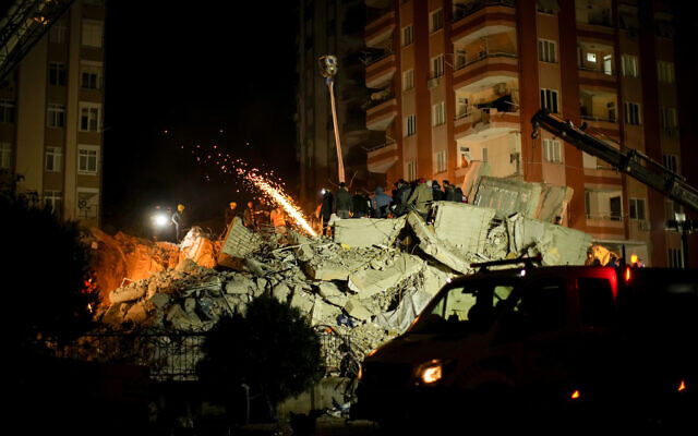 Emergency team members search for people in a destroyed building in Adana, Turkey, Tuesday, Feb. 7, 2023. (AP/Francisco Seco)