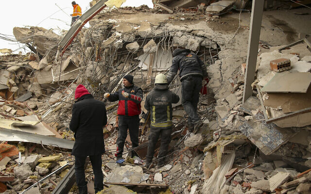 Rescue workers search for survivors on a collapsed building in Malatya, Turkey, Tuesday, Feb. 7, 2023. Search teams and aid are pouring into Turkey and Syria as rescuers working in freezing temperatures dig through the remains of buildings flattened by a magnitude 7.8 earthquake. (AP/Emrah Gurel)