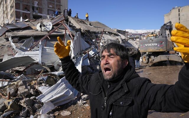 A man reacts, after rescue teams found his father dead under a collapsed building, in Kahramanmaras, southern Turkey, February 8, 2023. (Hussein Malla/AP)