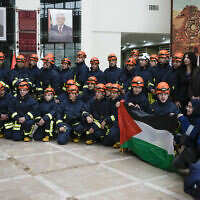 A Palestinian civil defense team including members of the Palestinian Authority's Ministry of Health and the Palestinian Red Crescent, pose for a group photo before they travel to Syria and Turkey, in the West Bank city of Ramallah, February 9, 2023. (AP/Majdi Mohammed)