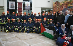 A Palestinian civil defense team including members of the Palestinian Authority's Ministry of Health and the Palestinian Red Crescent, pose for a group photo before they travel to Syria and Turkey, in the West Bank city of Ramallah, February 9, 2023. (AP/Majdi Mohammed)