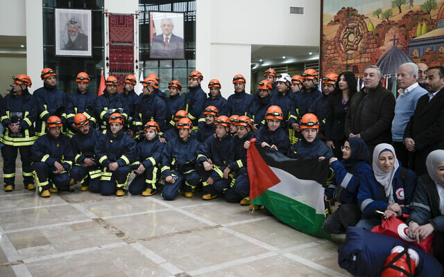 A Palestinian civil defense team including members of the Palestinian Authority's Ministry of Health and the Palestinian Red Crescent, pose for a group photo before they travel to Syria and Turkey, in the West Bank city of Ramallah, February 9, 2023. (AP Photo/Majdi Mohammed)