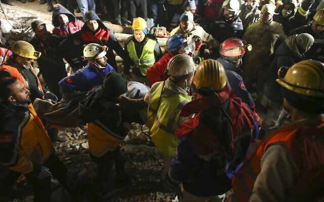 Rescue workers pull out a young woman from a collapsed building in Adiyaman, southern Turkey, Thursday, Feb. 9, 2023. (AP/Emrah Gurel)