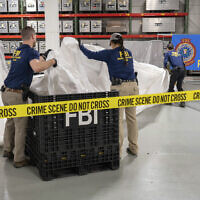 FBI special agents assigned to the evidence response team process material recovered from the high altitude balloon recovered off the coast of South Carolina, February 9, 2023, at the FBI laboratory in Quantico, Virginia. (FBI via AP)