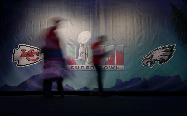 People are blurred by a long exposure as they arrive at the NFL Experience on February 11, 2023, in Phoenix, Arizona. (AP Photo/Charlie Riedel)
