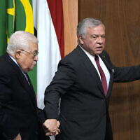 Palestinian Authority President Mahmoud Abbas, left, is accompanied by King Abdullah II of Jordan, during a conference at the Arab League headquarters in Cairo, Egypt, Sunday, Feb. 12, 2023. (AP Photo/Amr Nabil)