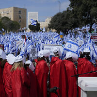 Israelis wearing costumes from 'The Handmaid's Tale' participate in a protest rally against plans by Prime Minister Benjamin Netanyahu's new government to overhaul the judicial system, outside the Knesset in Jerusalem, February 13, 2023. (AP Photo/Ohad Zwigenberg)
