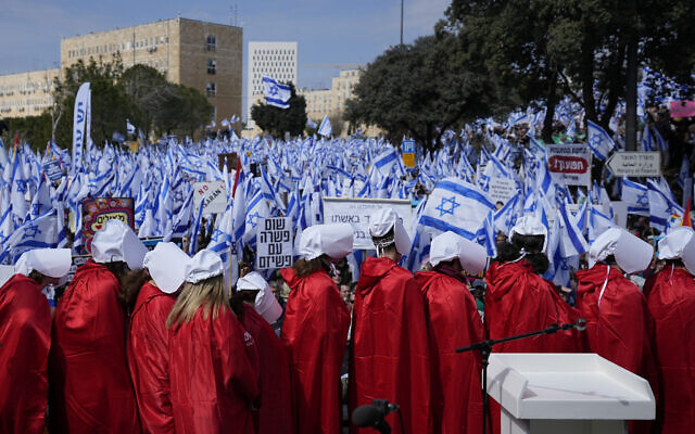 Israelis wearing costumes from 'The Handmaid's Tale' participate in a protest rally against plans by Prime Minister Benjamin Netanyahu's new government to overhaul the judicial system, outside the Knesset in Jerusalem, February 13, 2023. (AP Photo/Ohad Zwigenberg)