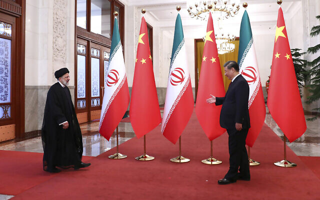 Iranian President Ebrahim Raisi, left, arrives in an official welcoming ceremony by his Chinese counterpart Xi Jinping in Beijing, February 14, 2023. (Iranian Presidency Office via AP)