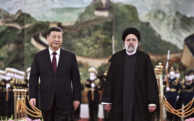 In this photo released by Xinhua News Agency, visiting Iranian President Ebrahim Raisi, right, walks with Chinese President Xi Jinping after reviewing an honor guard during a welcome ceremony at the Great Hall of the People in Beijing, Tuesday, February 14, 2023. (Yan Yan/Xinhua via AP, File)