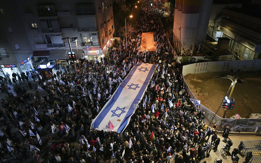 Israelis march during a protest against plans by Prime Minister Benjamin Netanyahu's new government to overhaul the judicial system, in Tel Aviv, Israel, February 18, 2023. (AP/Tsafrir Abayov)