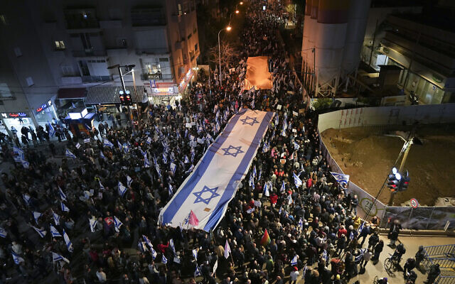 Israelis march during a protest against plans by Prime Minister Benjamin Netanyahu's new government to overhaul the judicial system, in Tel Aviv, Israel, February 18, 2023. (AP Photo/Tsafrir Abayov)