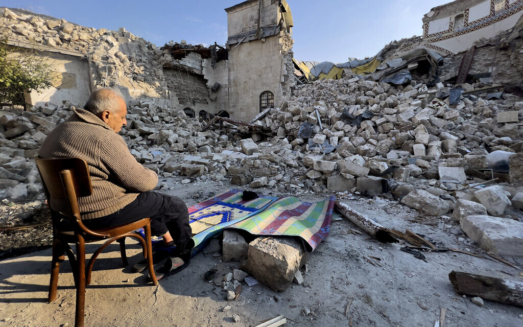 Turkish citizen Mehmet Ismet prays in front the rubble of the historic Habib Najjar mosque which destroyed during the devastated earthquake, in the old city of Antakya, Turkey, Saturday, February 11, 2023. Antakya, known as Antioch in ancient times, has been destroyed many times by earthquakes. It was destroyed yet again by an earthquake earlier this month, and residents are wondering if its ancient glories will ever come back. (AP Photo/Hussein Malla)
