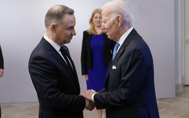 US President Joe Biden, right, is greeted by Polish President Andrzej Duda, at the Presidential Palace in Warsaw, February 22, 2023. (Evan Vucci/AP)