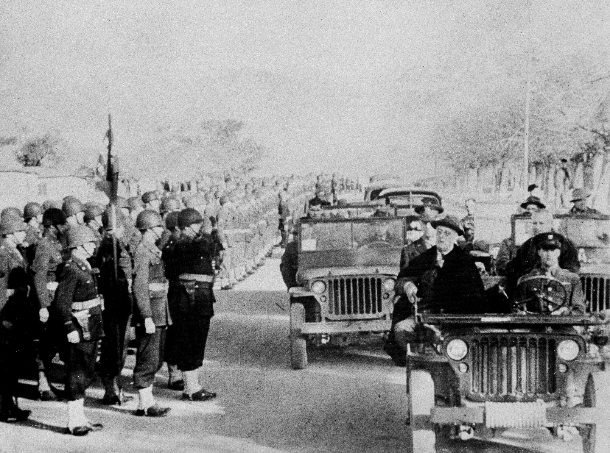 President Franklin D. Roosevelt reviews US troops from a jeep at an Army station in Tehran, Iran, after his conference with Winston Churchill and Joseph Stalin, December 14, 1943. (AP Photo/International News Photos)