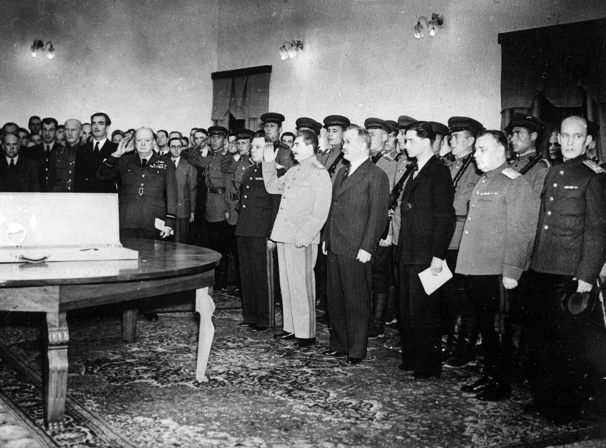 Josef Stalin and Winston Churchill salute their national anthems during the presentation of the Sword of Stalingrad, a gift from Britain's King George VI to the people of Stalingrad, on the table, at the Soviet legation in Tehran, Iran, in November 1943. (AP Photo/British Official Photo)