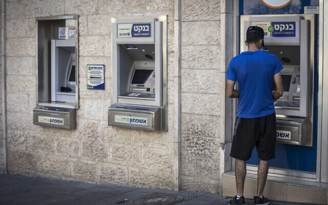 A man uses an ATM machine on Hillel Street in downtown Jerusalem on October 7, 2020. (Nati Shohat/Flash90)