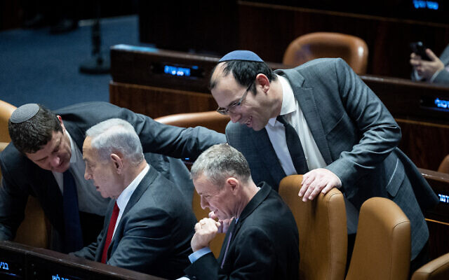 Prime Minister Benjamin Netanyahu, second from left, with Justice Minister Yariv Levin, center, and MK Simcha Rothman, right, during a vote in the Knesset, February 15, 2023. (Yonatan Sindel/Flash90)