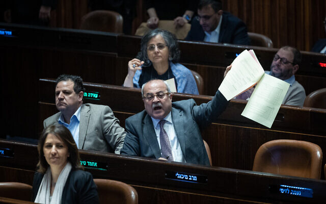 Hadash-Ta'al MKs Ayman Odeh (l) and Ahmad Tibi during a vote in the Knesset in Jerusalem, on February 15, 2023. (Yonatan Sindel/Flash90)