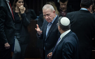 Defense Minister Yoav Gallant, center, speaks to National Security Minister Itamar Ben Gvir after a Knesset vote in Jerusalem, February 15, 2023. (Yonatan Sindel/Flash90)