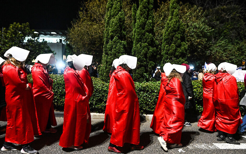 Protesters dressed as 'Handmaids' at a Haifa demonstration against the government's planned judicial overhaul, February 18, 2023. (FLASH90)