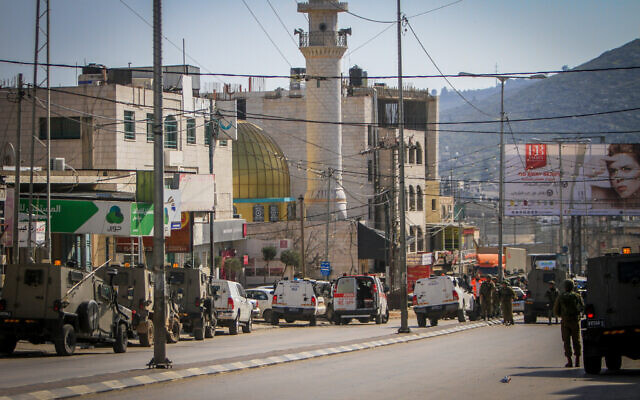 Israeli security forces secure the scene of a shooting attack in Huwara, in the West Bank, near Nablus, February 26, 2023. (Nasser Ishtayeh/Flash90)