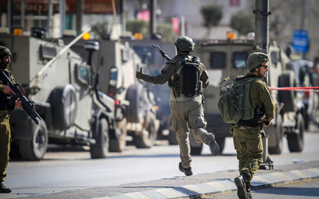 Illustrative: Israeli security forces secure the scene of a shooting attack where two Israelis were killed in Hawara, in the West Bank, near Nablus, February 26, 2023. (Nasser Ishtayeh/Flash90)