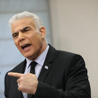 Head of the Yesh Atid party MK Yair Lapid speaks during a faction meeting at the Knesset on February 27, 2023. (Noam Revkin Fenton/Flash90)