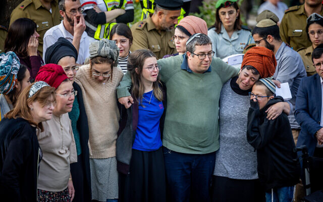 The parents and siblings of Hallel, 21, and Yagel Yaniv, 19, mourn during their funeral at the Mount Herzl military cemetery in Jerusalem, February 27, 2023. (Yonatan Sindel/Flash90)