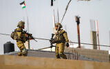 Israeli soldiers stand guard in Huwara, in the West Bank, near Nablus, February 28, 2023. (Nasser Ishtayeh/Flash90)